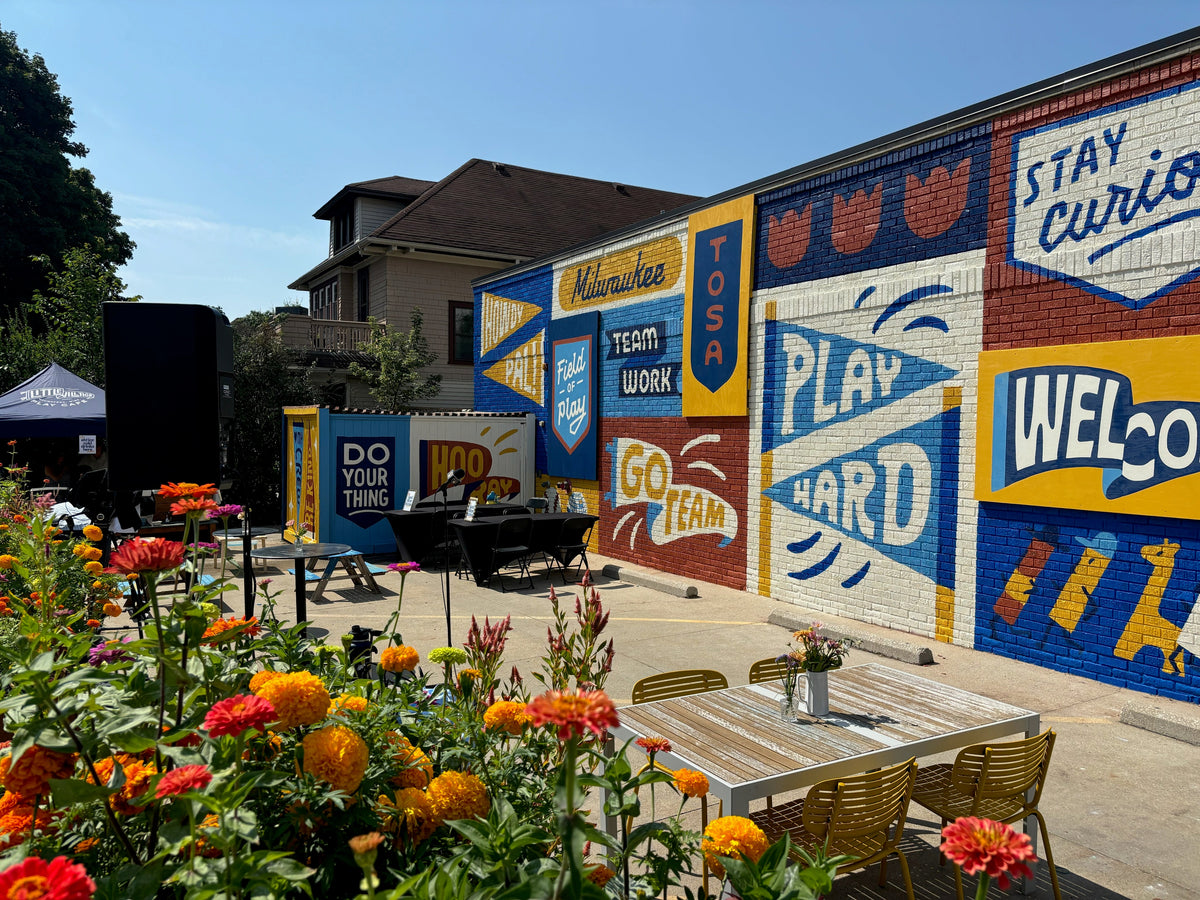 The colorful Field of Play Brewers mural by Whitney Nettles on the side of Little Village Play Cafe